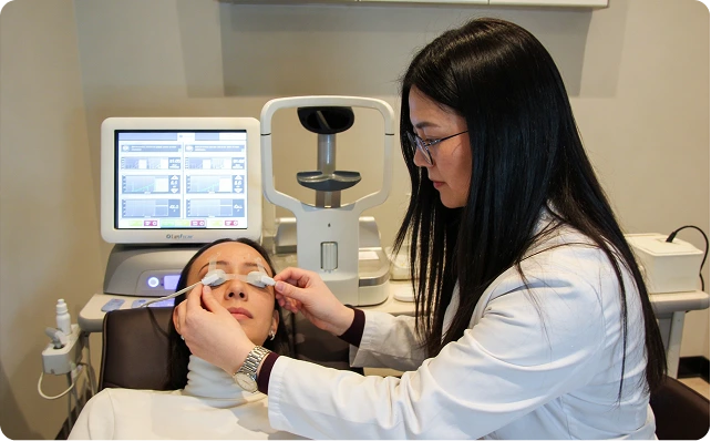 A patient consulting an optometrist in an advanced diagnostic room - LindsayWhispers SEO