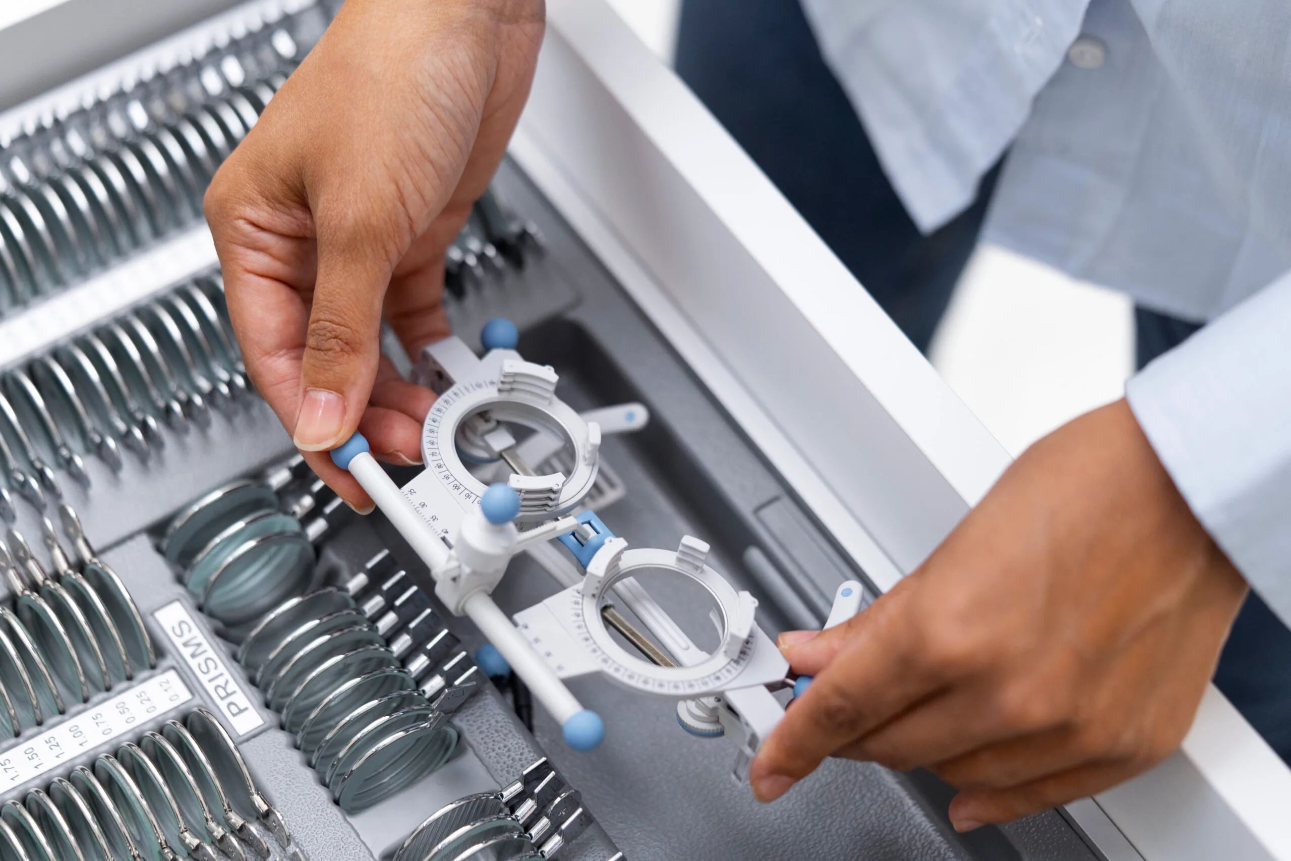 optometrist going through different lenses in a frame kit